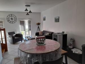 a living room with a table in the middle at la porte du Champagne in Hautvillers