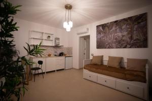 a bedroom with a bed and a kitchen in it at AirPort NOA Modern Home in Fiumicino