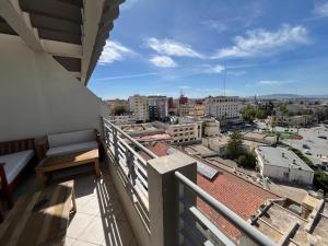 a balcony with a view of a city at Hotel Malta in Meknès