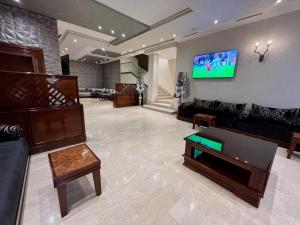 梅克內斯的住宿－馬耳他酒店，客厅配有沙发和墙上的电视