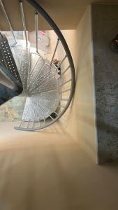 a spiral staircase in a room with a mirror at Mini Villa in Alfeld Leine in Alfeld