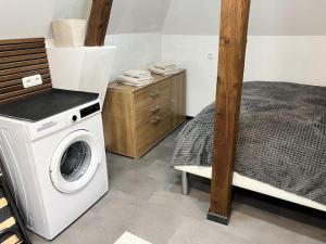 a laundry room with a washing machine and a bed at Mini Villa in Alfeld Leine in Alfeld