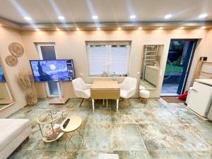 a living room with a couch and a tv at Mini Villa in Alfeld Leine in Alfeld