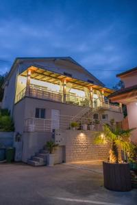 a large house with lights on the side of it at Apartmani Vesić in Tivat