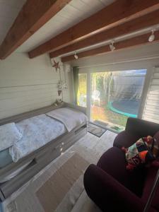 a bedroom with a bed and a couch and a pool at 29 park avenue in Shoreham-by-Sea