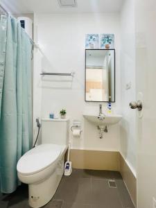 a bathroom with a toilet and a sink at WV 11 Sleek and Cozy Studio in Iloilo City
