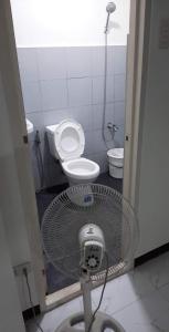 a small bathroom with a toilet and a fan at Casa Emerita in Santa Rosa