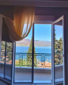 a room with a window with a view of the water at Skiff_View in Kastoria