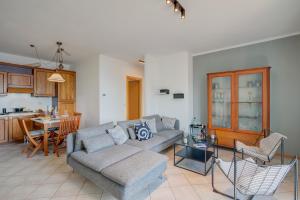 a living room with a couch and a table at Balcone sul Lago - Happy Rentals in Tremosine Sul Garda