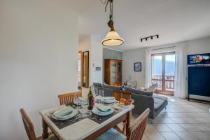 Un comedor y una sala de estar con mesa y sillas. en Balcone sul Lago - Happy Rentals, en Tremosine Sul Garda