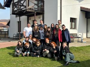 a group of people posing for a picture in front of a building at Pensiunea Eden in Bărăşti