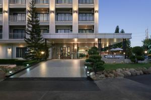 un edificio con una piscina di fronte di Golden Foyer Suvarnabhumi Airport Hotel a Lat Krabang