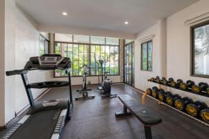 an empty gym with a treadmill and weights at Golden Foyer Suvarnabhumi Airport Hotel in Lat Krabang