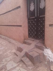 a door with a cross on the ground in front of a building at Paw's Cozy room in Hārer