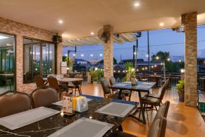 a restaurant with tables and chairs on a patio at Golden Foyer Suvarnabhumi Airport Hotel in Lat Krabang