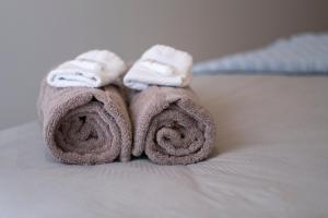 a pair of towels sitting on top of a bed at Modern, Ground floor , CBD, Free parking, 2-3 Beds in Christchurch +26 photos