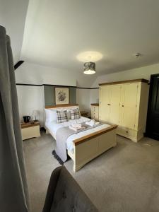 a bedroom with a large bed and yellow cabinets at The Fishmongers Tavern in Sheringham