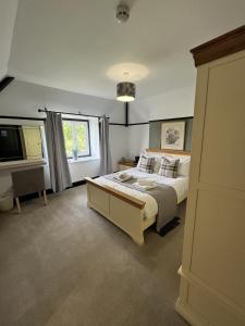 a bedroom with a large bed and a television at The Fishmongers Tavern in Sheringham