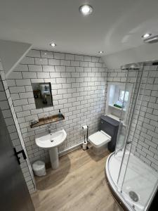 a bathroom with a sink and a shower and a toilet at The Fishmongers Tavern in Sheringham +37 photos