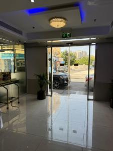 a lobby with a glass door with a car parked in a parking lot at Furnished Deluxe Private Studio Apartments near Union Metro Station in Dubai