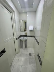 a white bathroom with a toilet and a shower at Furnished Deluxe Private Studio Apartments near Union Metro Station in Dubai