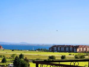 a view of the water and a building with a bench at Famagusta Antoniya in Aheloy