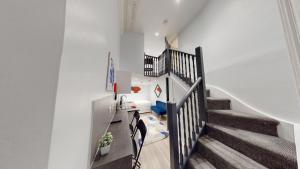 a staircase in a home with white walls at MSK Premium in London