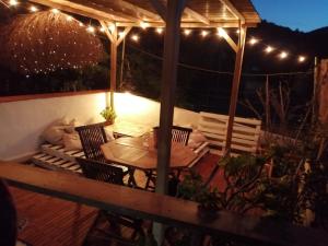 a patio with a table and chairs and lights at Cavo Beach 5 in Cavo