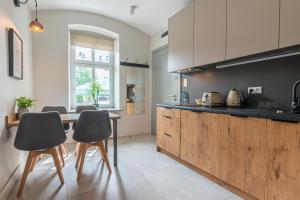 a kitchen with a wooden counter and a table at STAYPOLSKA in Oświęcim