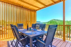 a wooden deck with a table and chairs on it at D&M mobile home in Drage