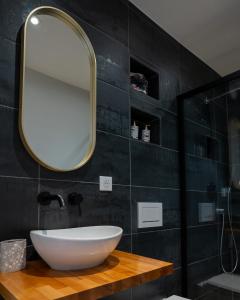 a bathroom with a white sink and a mirror at Basel Airport Stay in Blotzheim