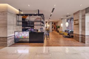 a lobby of a store with a counter and chairs at Hotel Royal Signature in Kuala Lumpur