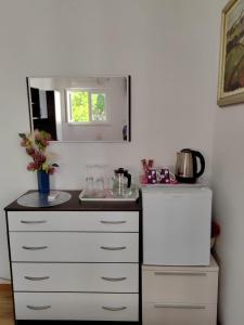 a kitchen with a counter and a sink and a mirror at Guesthouse MM in Dubrovnik