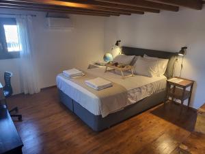 a bedroom with a large bed with a table on it at Saint George House in Ierapetra