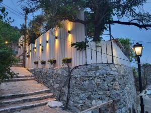a stone wall with a gate and a street light at Saint George House in Ierapetra