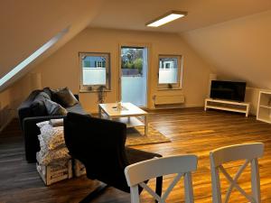 un soggiorno con un divano e un tavolo di Ferienwohnung im Resi Gesundheitszentrum a Freudenberg Altre 12 foto