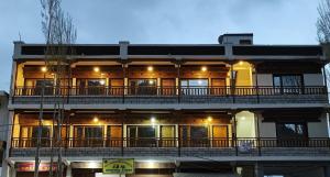a large building with a balcony on top of it at Zanu Residency in Leh +10 photos