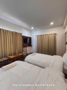 Tempat tidur dalam kamar di Zanu Residency