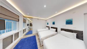 two beds in a room with a flat screen tv at MSK Premium in London