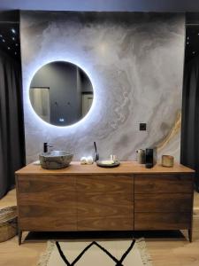 a bathroom with a sink and a mirror at La Jonquette in Francheval