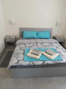 a bedroom with a bed with two towels on it at Apartmani-Sobe Manić in Soko Banja