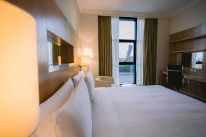 a hotel room with a large bed with a window at Holiday Inn Abu Dhabi by IHG in Abu Dhabi