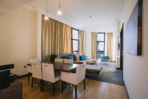 a living room with a table and chairs and a couch at Holiday Inn Abu Dhabi by IHG in Abu Dhabi