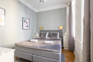 een slaapkamer met een groot bed met witte muren bij Large Flat with Canal View in Central CPH City in Kopenhagen