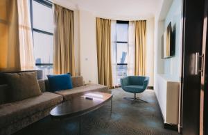 a living room with a couch and a table at Holiday Inn Abu Dhabi by IHG in Abu Dhabi