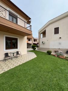 a yard with two chairs and a table in front of a house at Penelope's Maisonette in Skala Potamias