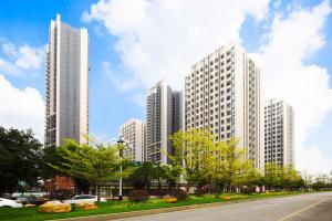 a row of tall buildings in a city at Serveyou International Apartment - Free Airport Pickup Service & Free Pazhou Complex Shuttle Bus & Free Sanyuan Li Xiaobei Baiyun Wholesale Market shuttle bus in Guangzhou