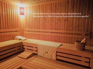a sauna with two benches and a bucket in it at Autenrieder Gästehaus Schlossbräu in Autenried