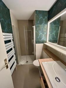 a bathroom with a shower and a sink and a toilet at Ferienwohnung „mittendrin“ in Zinnowitz +6 photos