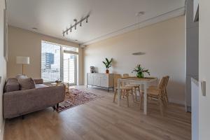 een woonkamer met een bank en een tafel bij Cozy apartment with huge terrace in Vilnius
